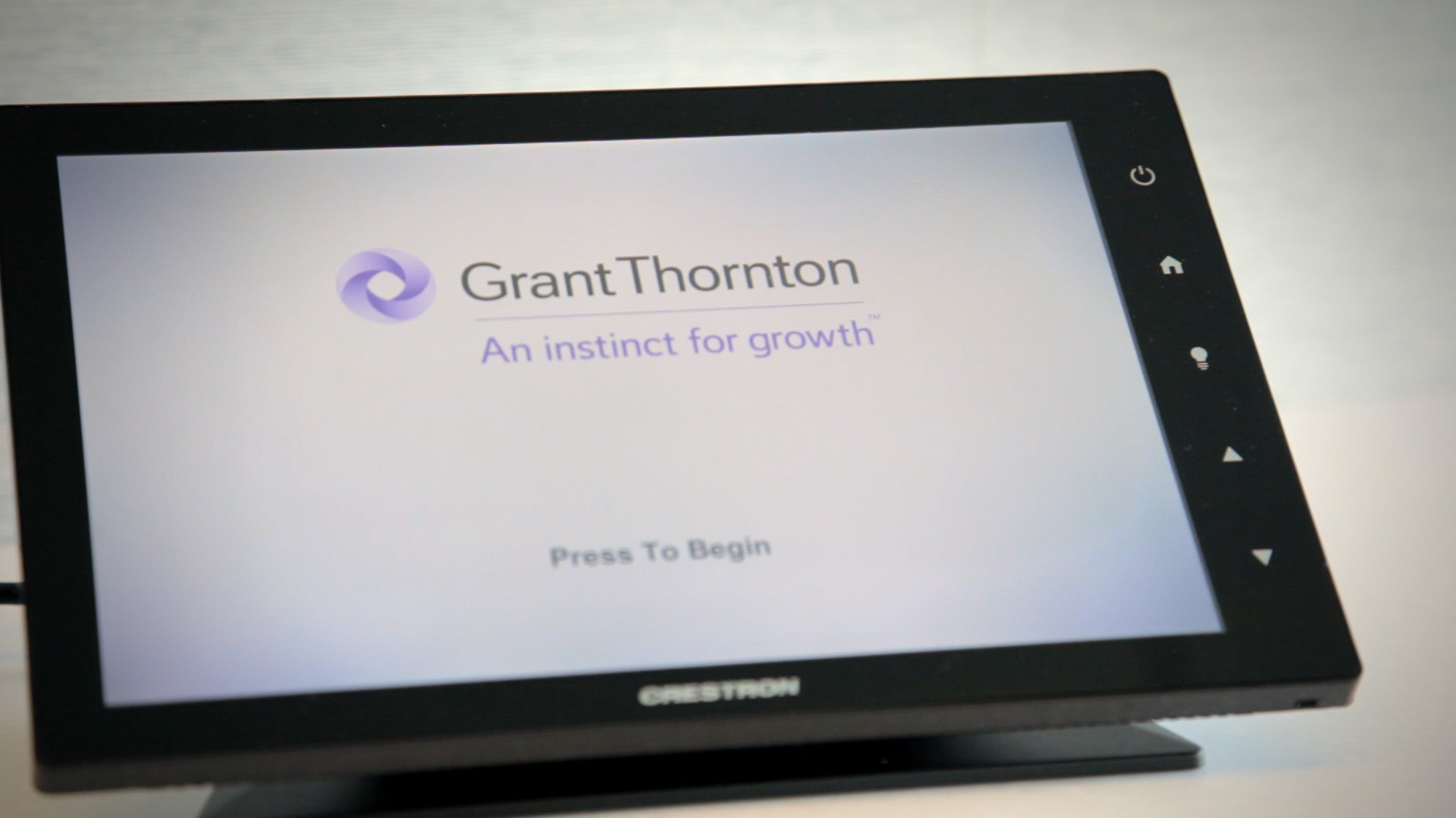 Touchscreen display showing Grant Thornton logo and tagline "An instinct for growth" with "Press To Begin" prompt.