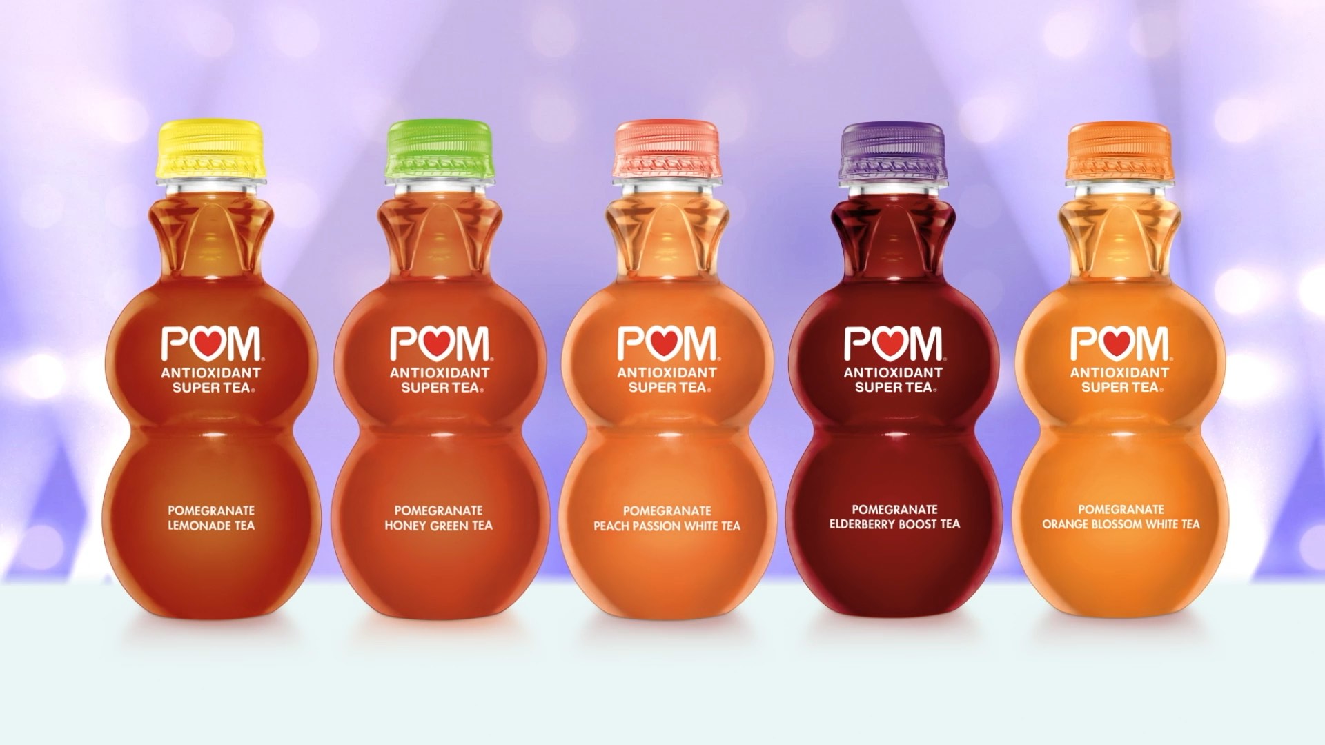 Five POM Antioxidant Super Tea bottles in various colors and flavors on a soft purple background.