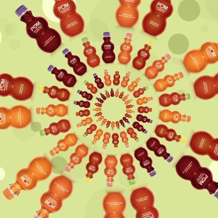 Bottles of juice arranged in a circular pattern on a green, dotted background.